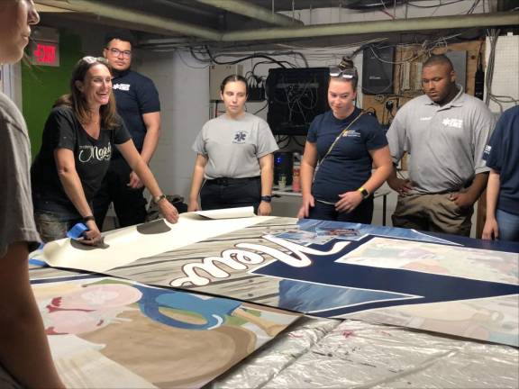 From left are artist Caren Olmsted, who designed the mural, and Newton First Aid Squad members Will Taylor, Kelly Ellsworth, Lauren Hennighan and Caiden Schabacker.