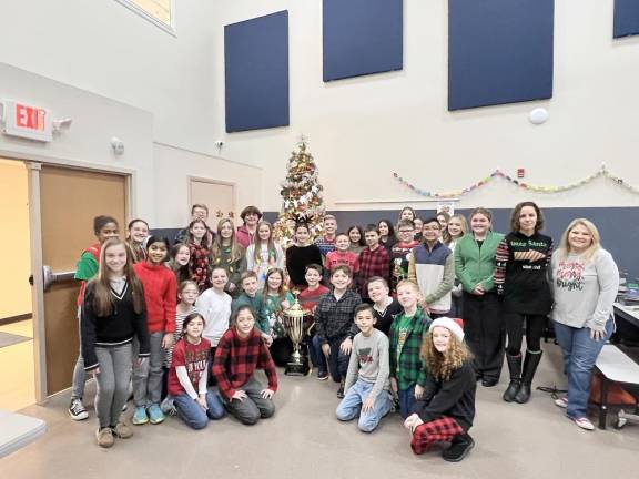 Students at Pope John XXIII Middle School in Sparta pose with the second-place Stuff the Stocking trophy. (Photos courtesy of Project Self-Sufficiency)