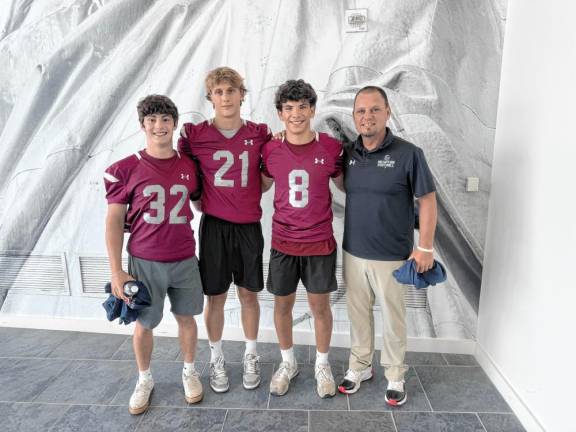 From left are Newton High School football players Anthony Tudda, Nick Kurilko and Matt Elsworth with head coach Matt Parzero. (Photo by Aidan Mastandrea)