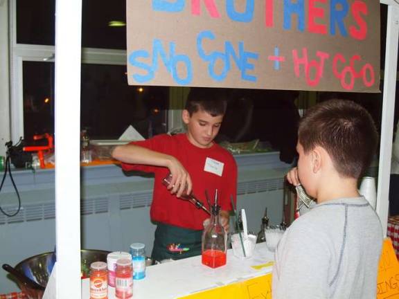 Miser Brothers co-ownerTravis Healy, 12, serves a customer a drink.