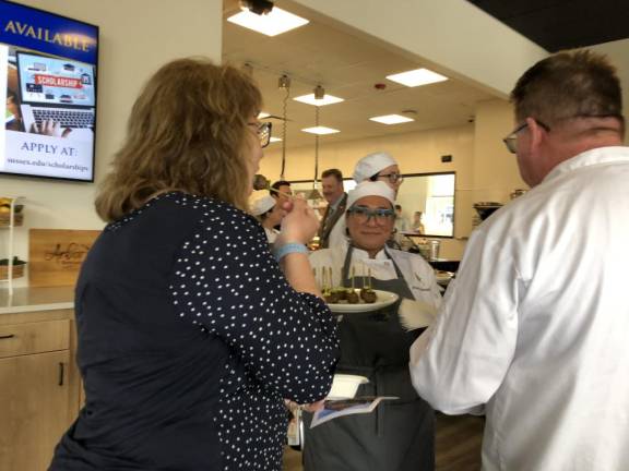 A Sussex County Communty College student serves hors d’oeuvres after the ribbon-cutting ceremony at the college’s new Culinary Institute.