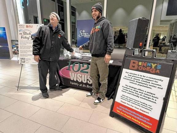 BB2 Steve Allen, left, of 102.3 WSUS and Benny’s Bodega founder Benjamin Davey pick the winning ticket.