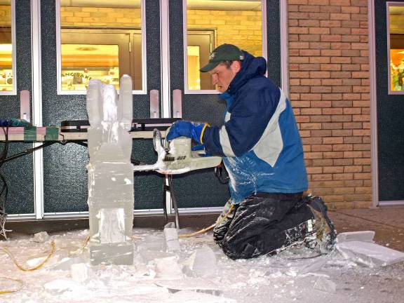 Sussex County Technical School Culinary arts instructor Chad Gasiorek, of Shohola, Pa., gets busy ice carving with a chainsaw 6:30 a.m. Thursday outside of the school.