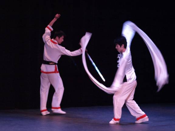 Dancers with a sword and long, flowing sleeves represent the yin and yang of life.