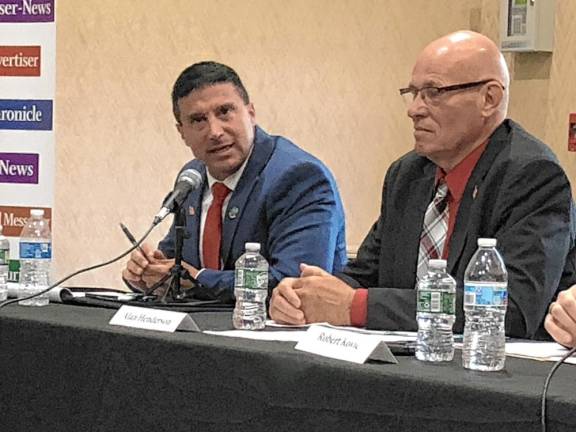 Chris Carney, left, answers a question while Alan Henderson listens. The two candidates are running as a slate for two seats on the Sussex County Board of County Commissioners.