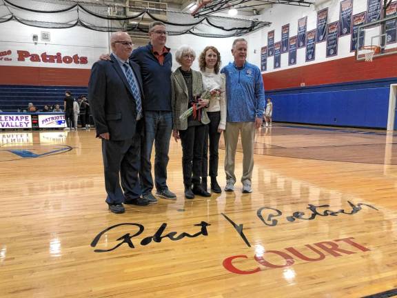 The basketball court at Lenape Valley Regional High School was named for the late coach Robert Poetsch in February. His widow, Judy, center, poses with her son, Robert, and daughter, Robyn. (Photos by Kathy Shwiff)