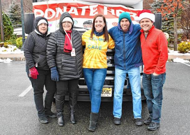 From left are Wendy Vangorden and Ruby Young of the Sussex County Division of Social Services, Lyndsay Wright of Provident Bank, Jeff Staple of Hamburg who is driving the bus and Steve Allan of radio station 102.3 WSUS.