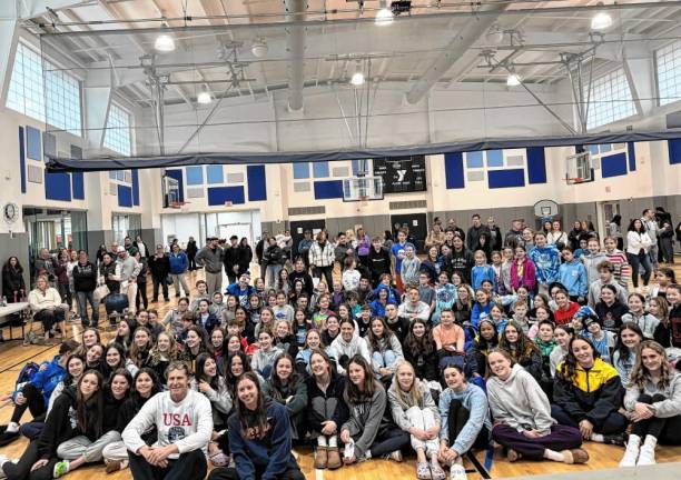 Swimmers pose for a photo with Olympic swimmers Kate Douglas and Josh Davis, in front.