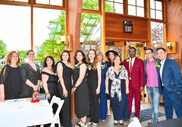 <b>Family Promise staff and volunteers pose at the Casino Night fundraiser. Fourth from right is executive director Chris Butto.</b>