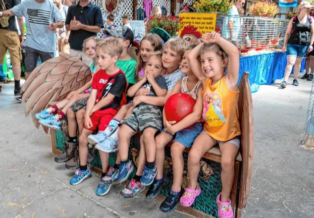 <b>The Morris family visits the animals at the fair. (Photo by Nancy Madacsi)</b>