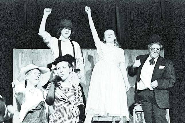 Noah Keppler, Phoebe Livingston and Sandi Livingston on stage as Tom Sawyer, Becky Thatcher and Judge Thatcher.