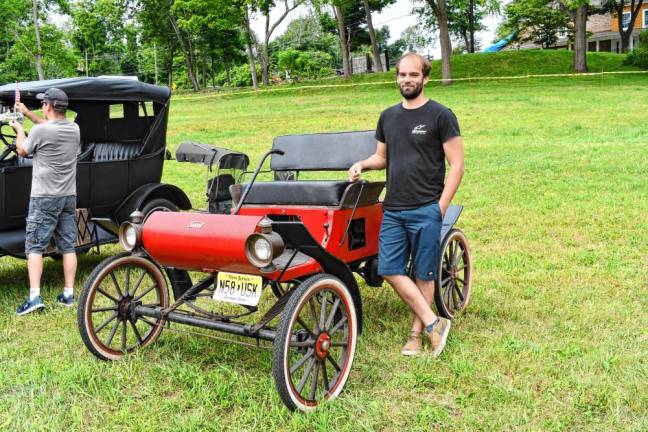 Eric Redding of Hampton Township stands by his red and black Surrey car.