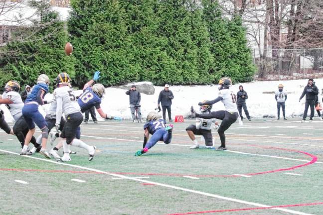 Pope John defenders Alex Schreiber (18) and Nick Vannatta (21) come close to blocking the ball during an extra-point kick attempt by St. John Vianney in the first half.