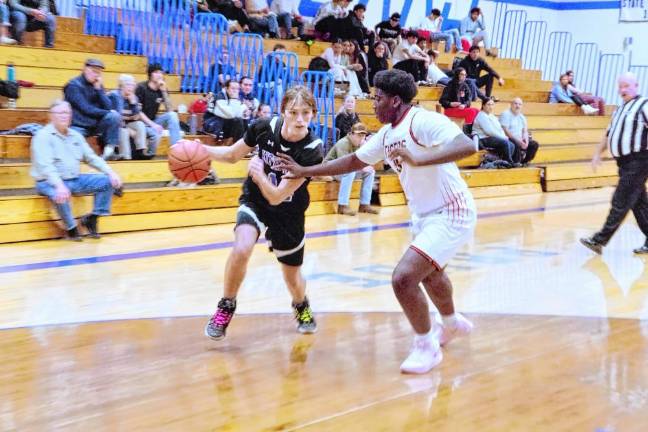 Kittatinny's Luke Kramer handles the ball while covered by Dover's Bradyn Brown. Kramer scored four points, grabbed five rebounds, made six assists and is credited with three steals.