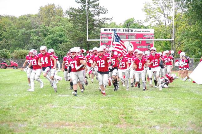 <b>The High Point Wildcats charge onto the field before the start of the game.</b>