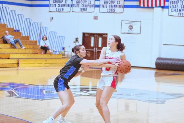 High Point’s Claire Sieminski holds the ball as Kittatinny’s Taylor Hough reaches for it. Sieminski scored five points.