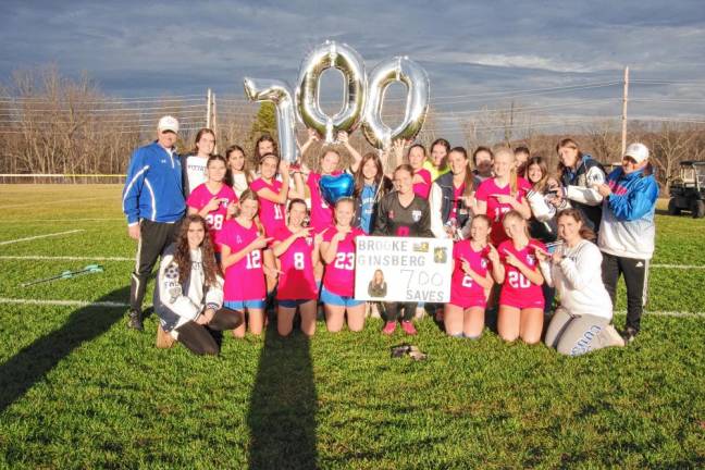 The Kittatinny players, coaches and support staff celebrate the victory and the 700th career save by goalie Brooke Ginsberg, center.