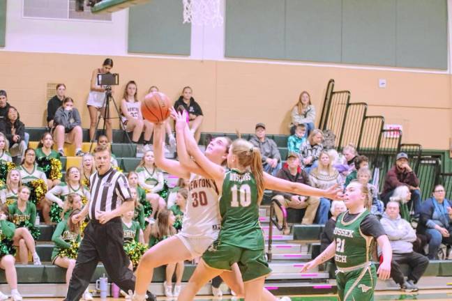 Newton’s Caitlyn Pokrywa (30) is fouled by Sussex Tech’s Emily Ursin (10) during a shot attempt in the first half of their game Dec. 19. Newton won, 49-20. (Photo by George Leroy Hunter)