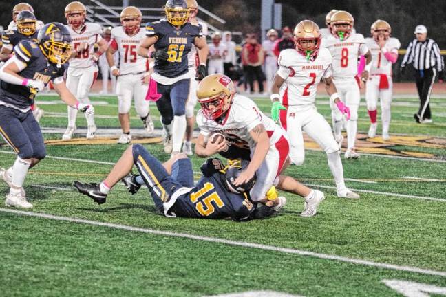 <b>Vernon defensive back Dean Grundy (15) takes down Mount Olive tight end Lincoln Youtz in the first half of the Vikings’ home game Thursday, Oct. 10. Mount Olive won, 28-0.</b>