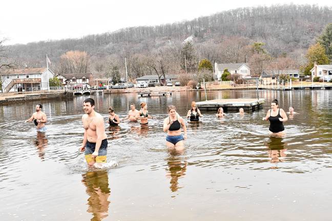 Participants in the annual Polar Plunge at Lake Lackawanna Beach in Stanhope head back out of the water Sunday, March 16.