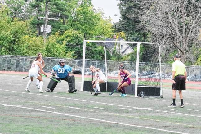 The ball is airborne in front of the Newton Braves goalpost.