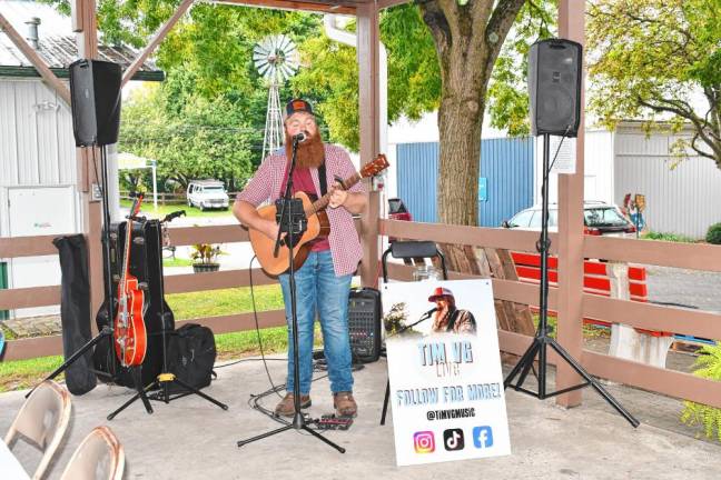 <b>Tim VanderGroef, a local country singer, performs at the event.</b>