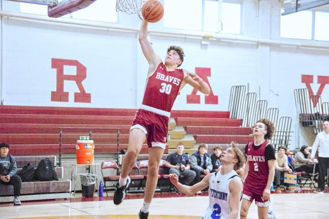 Newton's Maxwell Maslowski raises the ball during a shot in the game against Kittatinny on Tuesday, Feb. 11. The Braves won, 59-44, and Maslowski scored eight points. On Monday, Feb. 10, he scored the 1,000th point of his high school career in the game against Mount Olive. (Photos by George Leroy Hunter)