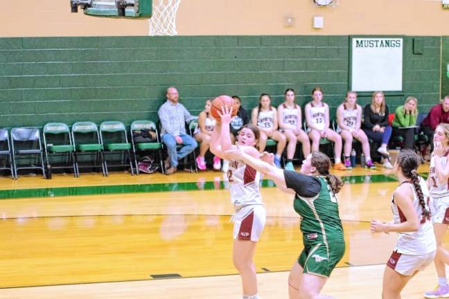 Newton’s Jordyn Young grabs the ball during a rebound. She scored 13 points and grabbed four rebounds. (Photos by George Leroy Hunter)