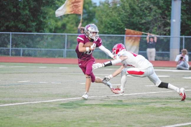 <b>Newton kick returner Hunter Wolfe attempts to avoid Lenape Valley defender Chase De Oliveira in the first quarter.</b>