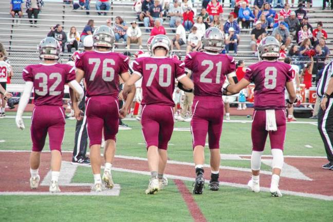 <b>From left, Newton Braves team captains Anthony Tudda, Ryan Corino, Sean Benitz, Nick Kurilko and Matt Ellsworth walk onto the field for the coin toss.</b>