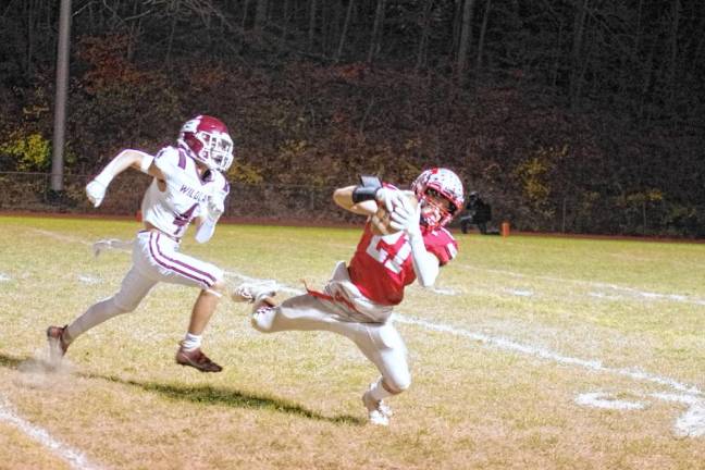 <b>High Point wideout Brendan Lehman catches the ball while being pursued by a Becton defender in the first half. (Photo by George Leroy Hunter)</b>