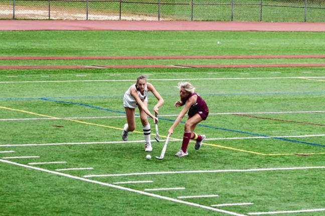 Voorhees's Abigail Sell and Newton's Olivia May reach for the ball in the third period.