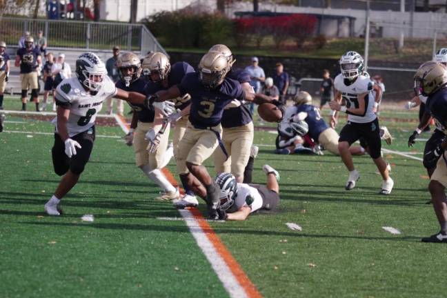 Pope John ball carrier Tylik Hill weaves his way through the St. Joseph of Metuchen defense Saturday, Oct. 28 in Sparta. The Lions lost the game, 10-6. (Photo by George Leroy Hunter)