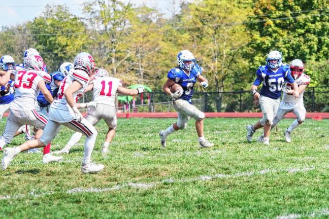 <b>Kittatinny ball carrier Kevin O'Keefe runs through an opening in the High Point defense in the third quarter.</b>