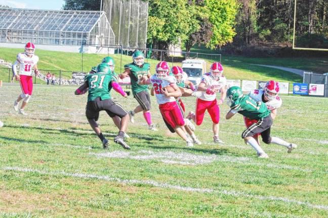 <b>LV1 Sussex Tech defenders pursue Lenape Valley ball carrier Kevin Giusti, who rushed for 289 yards and two touchdowns in their game Oct. 5. The Patriots won, 28-16. (File photos by George Leroy Hunter)</b>