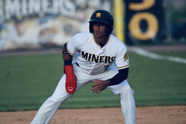 Outfielder Edwin Mateo leads off first base.