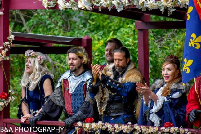 Members of the Royal Court applaud the entertainers.