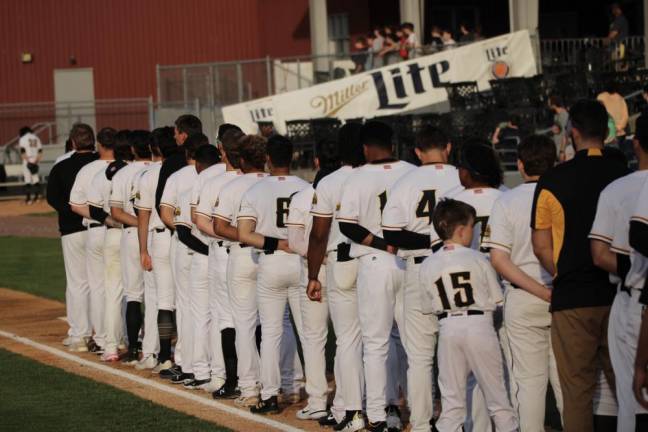 The team lines up for the National Anthem.