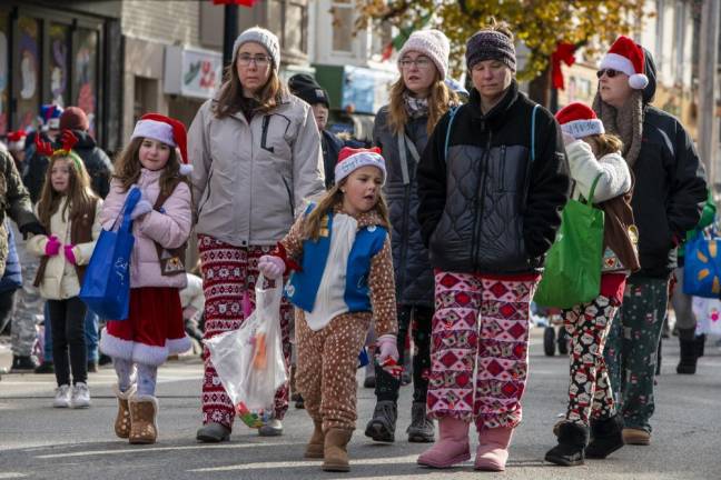 Members of Girl Scout Troop 98316 march in the parade.