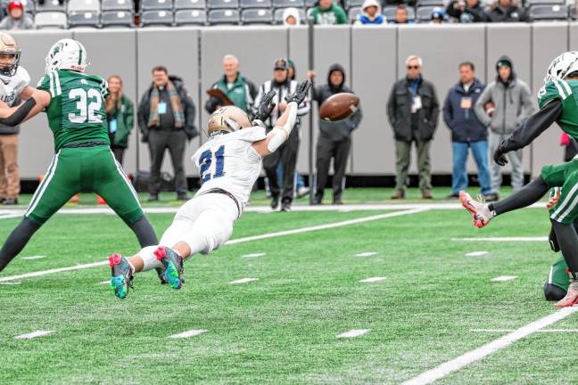 Andrew Sanchez of Pope John lays out to try to block the extra-point kick by DePaul’s Ryan Sayles.