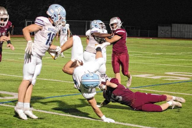 <b>Sparta ball carrier Christian Brevig uses his right hand to break his fall after being upended by a Newton defender in the second half. (Photos by George Leroy Hunter)</b>