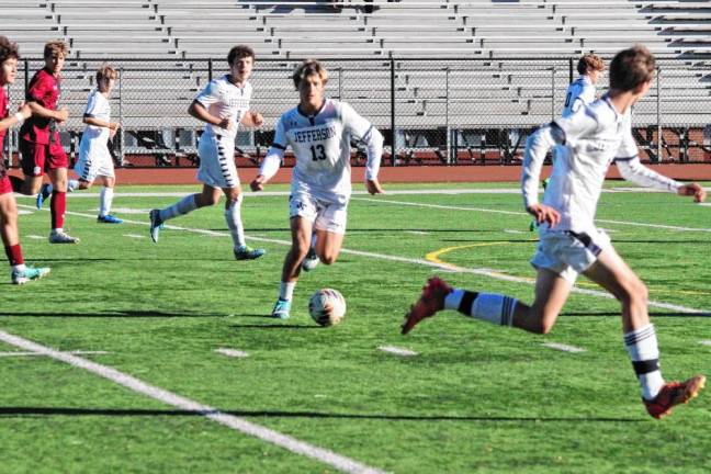 A Jefferson Falcon controls the ball in the first period.