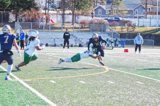 <b>Pope John quarterback Luke Irwin is tackled by Camden Catholic defender Terence Barnes resulting in a sack in the first half. (Photo by George Leroy Hunter)</b>