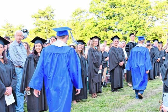 Graduates pass by Kittatinny’s faculty.