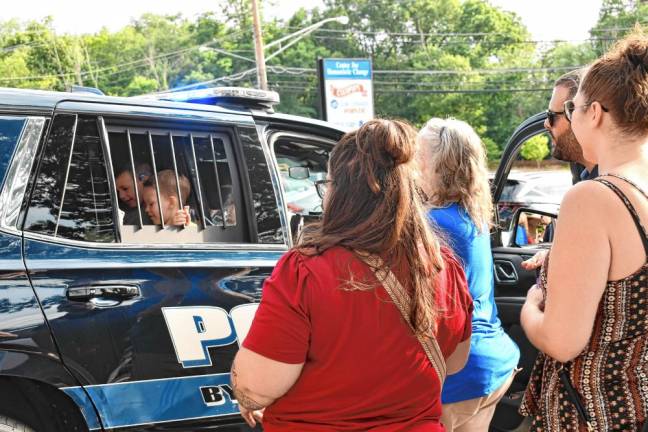 CC2 Two little boys check out the inside of a police car.