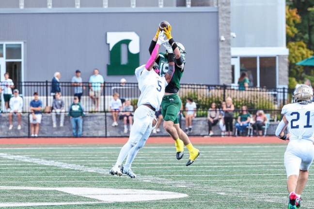 <b>Pope John’s Akei Griffin knocks the ball out of the hands of Delbarton’s Matt Taluri on a first-half pass play at midfield. (Photo by Glenn Clark)</b>