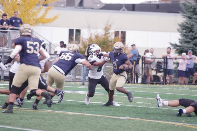 Pope John ball carrier Tylik Hill stiff-arms a St. Joseph of Metuchen defender Saturday, Oct. 28 in Sparta. The Lions lost the game, 10-6. (Photos by George Leroy Hunter)