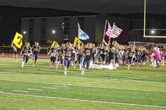 <b>The Vernon Township High School Vikings arrive on the field.</b>