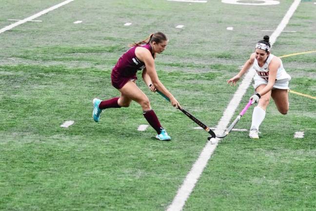 Newton's Caitlyn Neill and Voorhees's Isabella Settembrini reach for the ball in the third period.