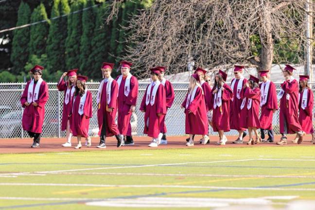 Members of the Newton High School Class of 2024 file into graduation Monday, June 17.